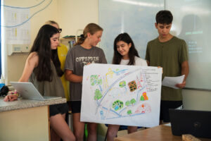 Image shows five students presenting in one of the final hackathons. 